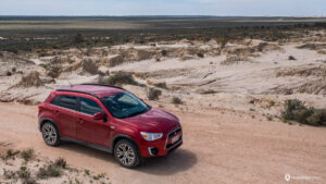 Australia_Mungo_NP-8 red car diving around mungo national park in Australia