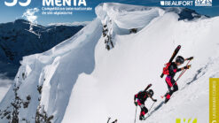 Guys climbing the snowy mountian with skimo skis on backpack