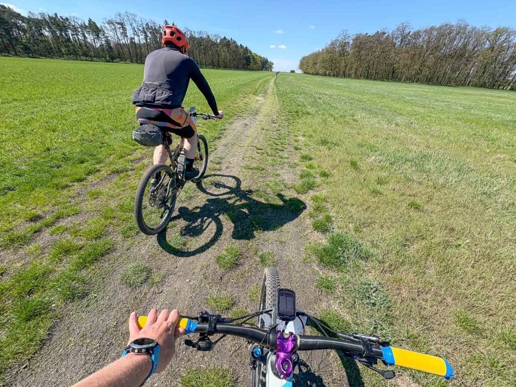 Two bike rider on a dusty path