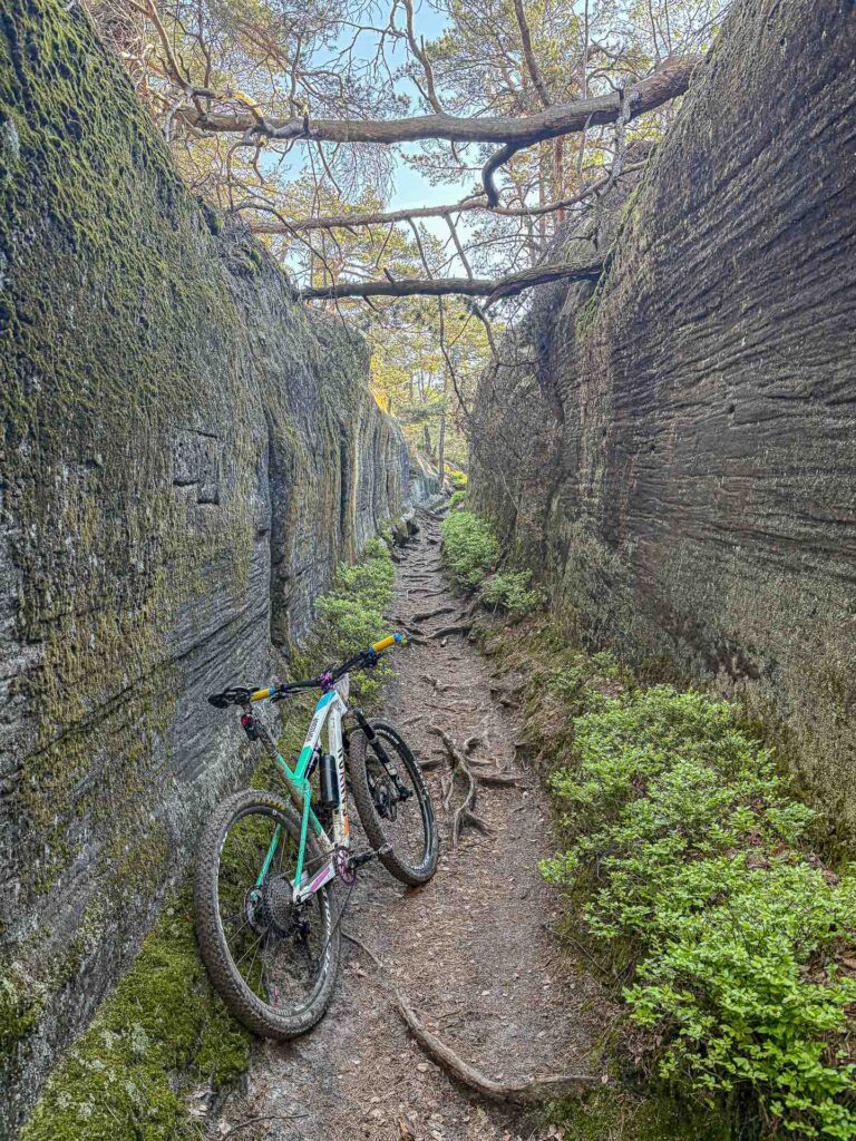 dirty bike in a narrow rocky aisle