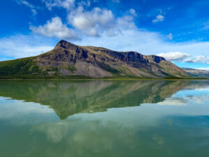 mirror like lake in Sweden with reflecting majestic mountain behind