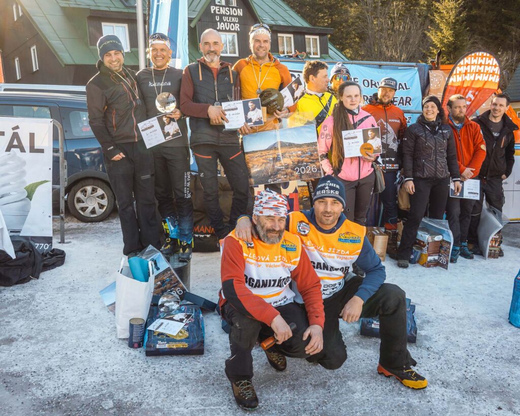 Team of the sleddog racers with organizator on the podium