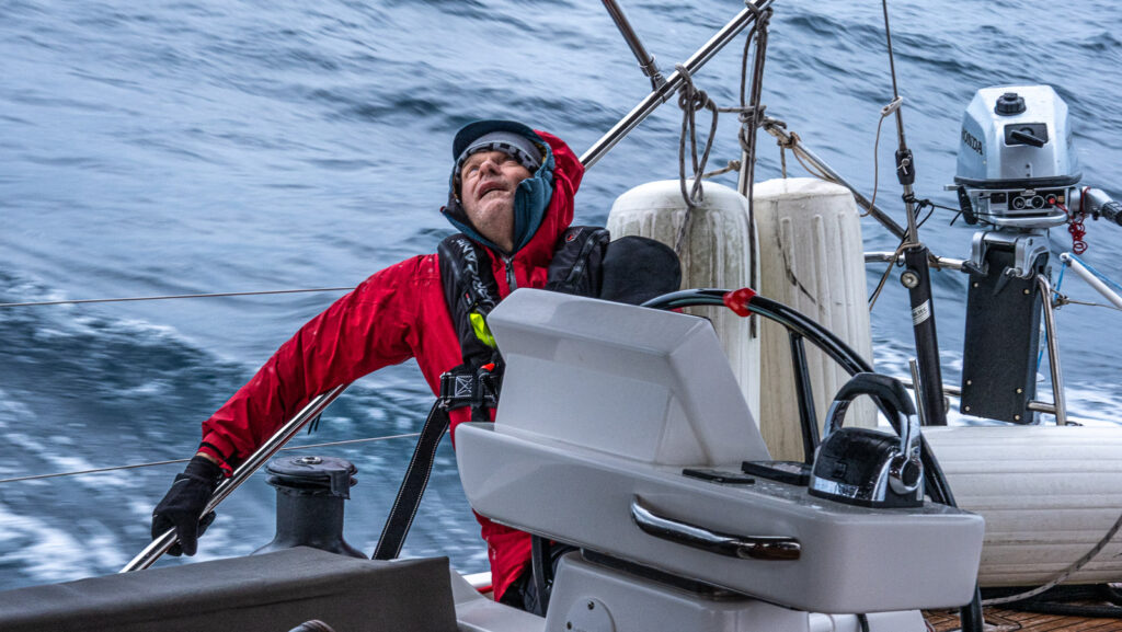 man trimming sails on the sail boat