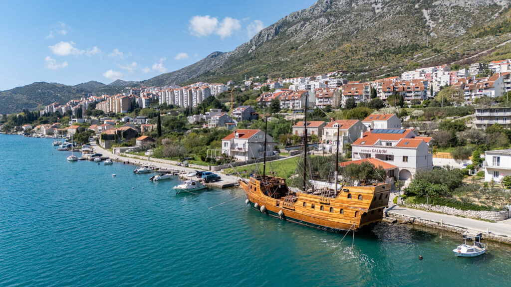 Old wooden ship in the dock in the mediterranean sea