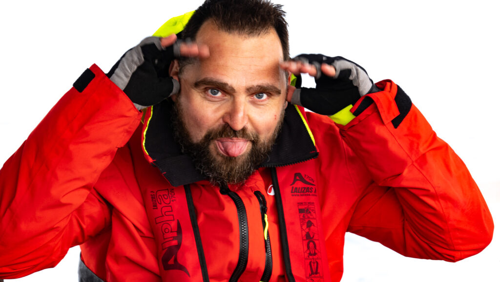 Man in sailing jacket and lifejacket posing on the picture