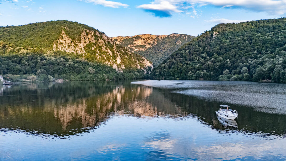 A sport boat anchoring near statue of Decebalus in Iron gates