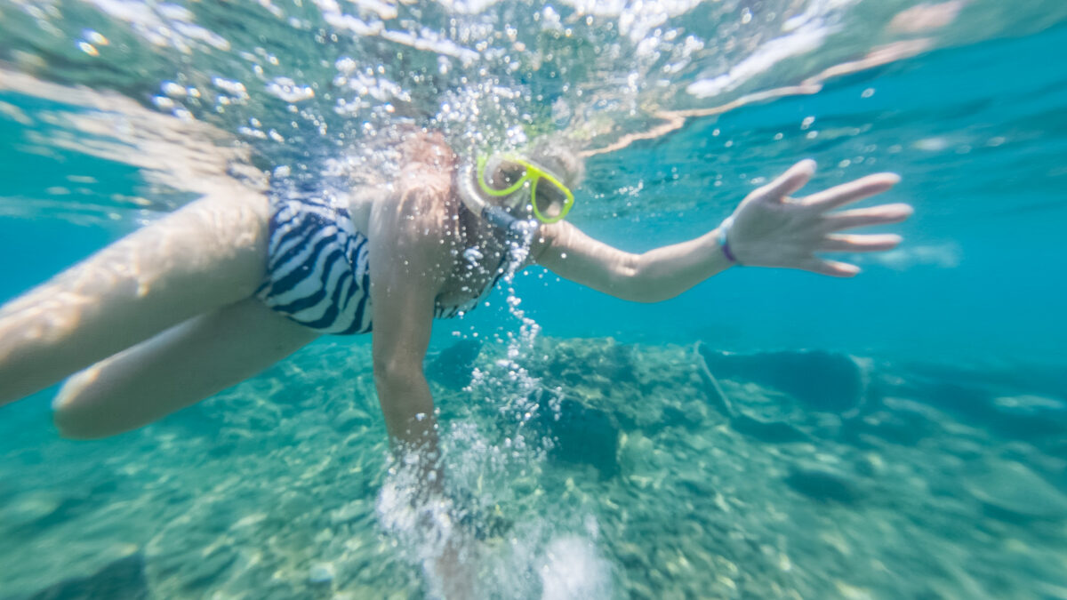 Underwater photography of a diving person near Epidaurus