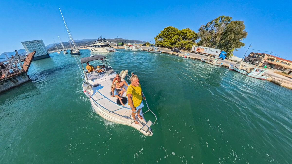 Boat crossing the Lefkada bridge with people on board